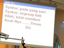 If you look closely at the screen displaying the text of a hymn being sung in a Malaysian Church, you can see the word Allah and Jesus (Yesus) being used. Photo Malaysian Church, Wikipedia:Vmenkov