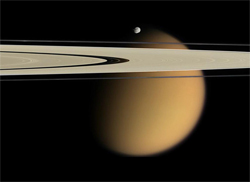 A photo of Titan taken by the Cassini spacecraft. Saturn's rings pictured in front of Titan. Photo Wikipedia/NASA