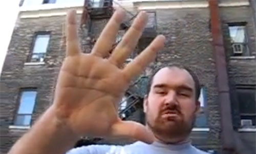 Jerry stands 7' 8'. His hand span is over a foot wide and he is wearing a custom made 6XL shirt: Image capture from youtube.com/Christopher Hughes