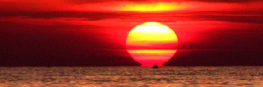 Ship sailing into the sunset. Photo: Ozgur Mulazimoglu/Flickr/Creative Commons