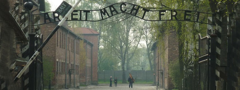 Entrance to the Auschwitz Concentration Camp. The sign reads "Work Sets You Free." Credit: Igor Griffiths/Flickr/Creative Commons