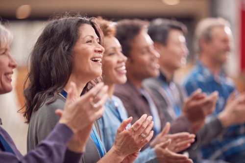 Group of people smiling and clapping