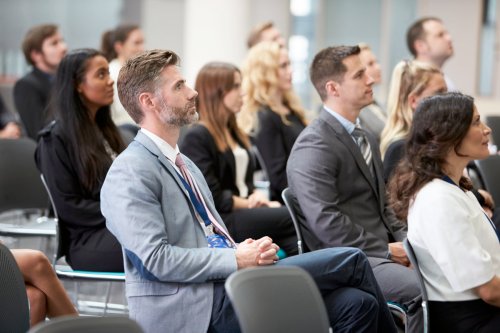 group of people listening to a speaker
