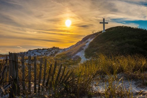 Cross on a hill at sunset