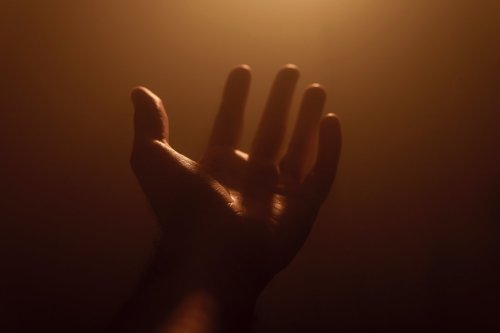 Hand lifted in prayer