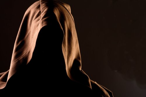 Person wearing a hood covering his face