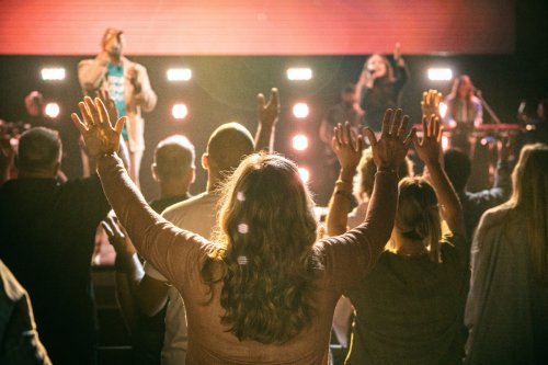 Christians raising hands in a church worship service