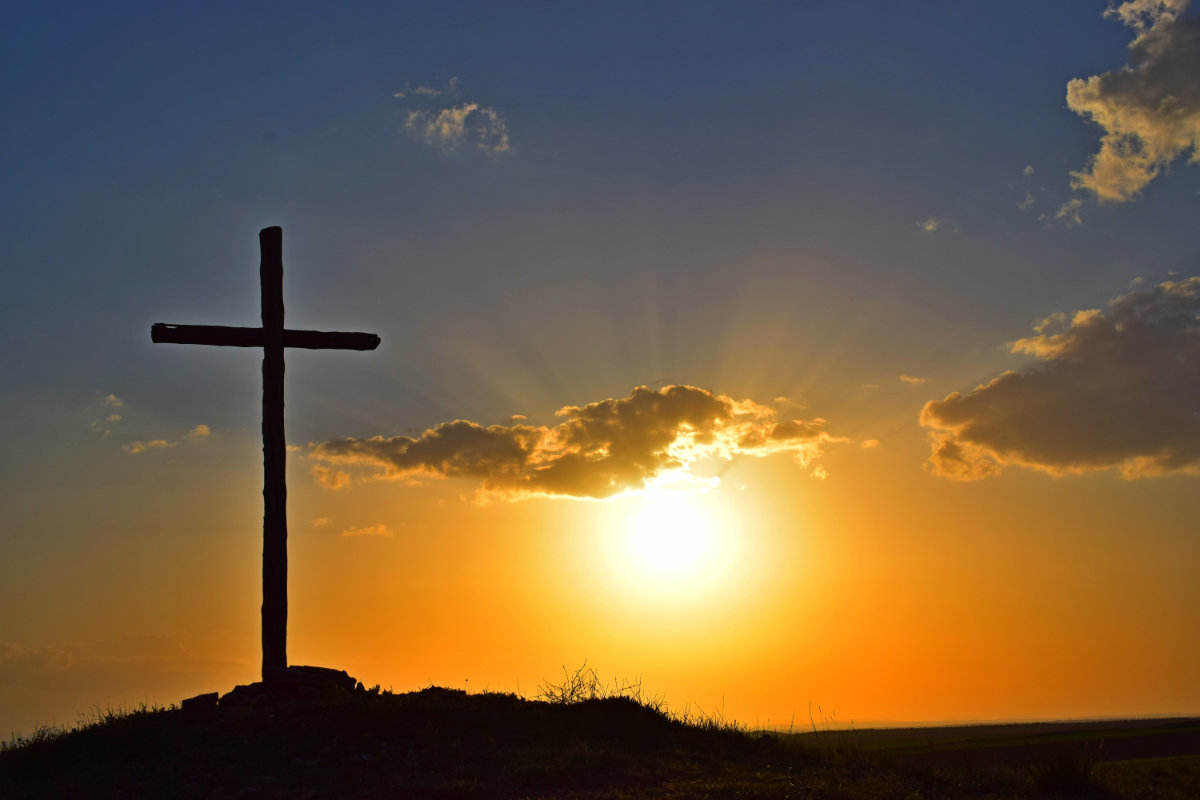 Cross on a hill at sunset