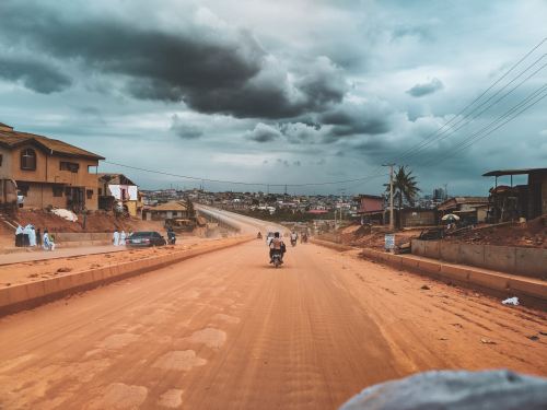 Traveling on a dirt road in Nigeria on a motorcycle