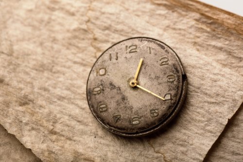 An old clock on a manuscript paper