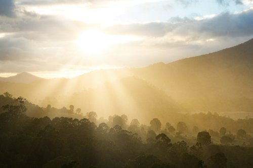Sun rays piercing through the sky at sunset