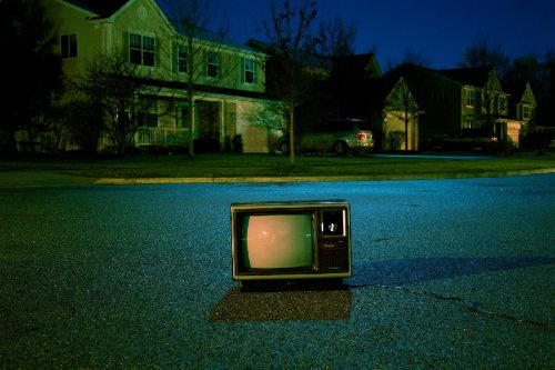 TV sitting on a street at night