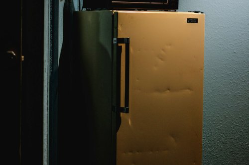 Battered old yellow fridge

