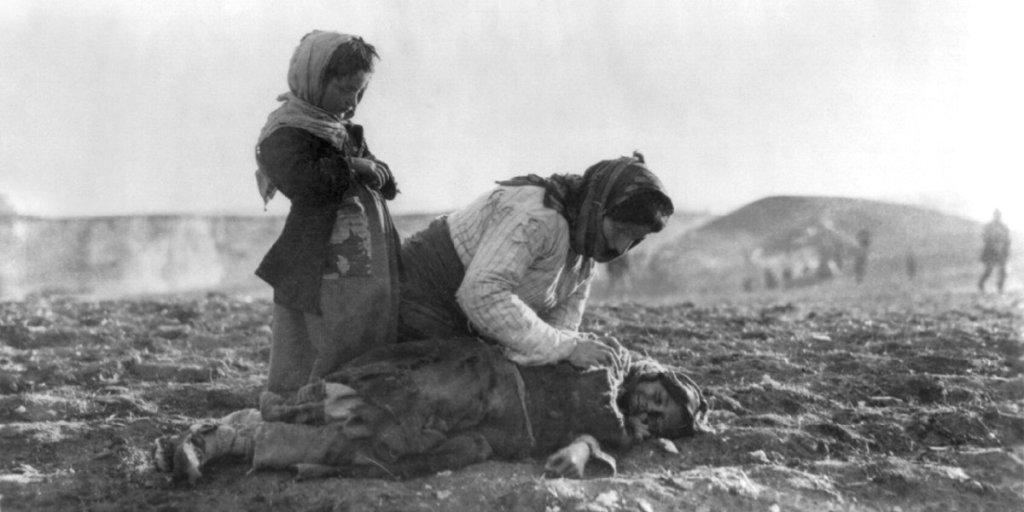 Armenian women kneeling beside dead child during Armenian genocide