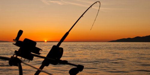 Fishing off a boat in the evening
