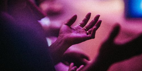 Hand raised in worship during church service
